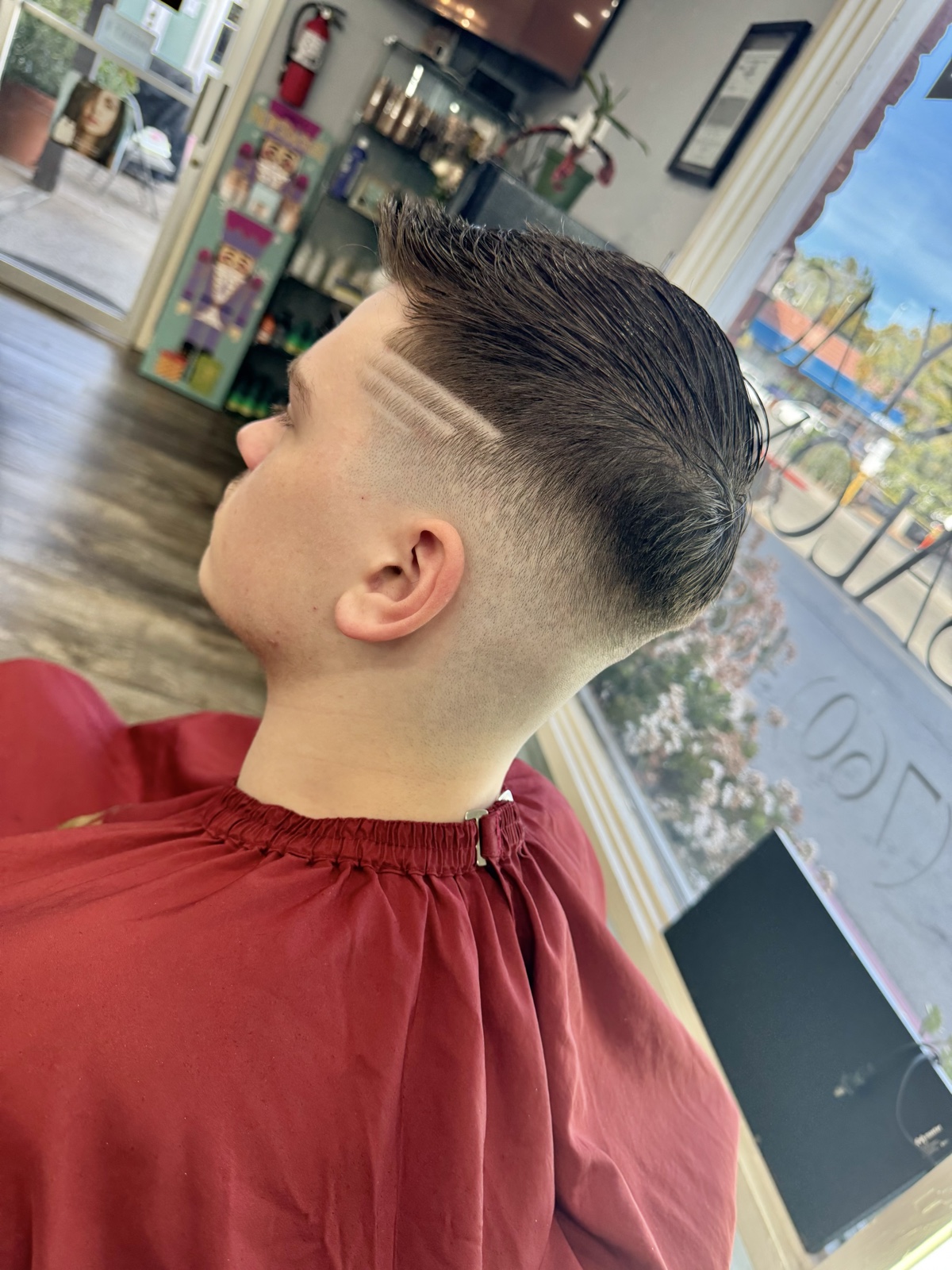 High fade with hair design and slick top