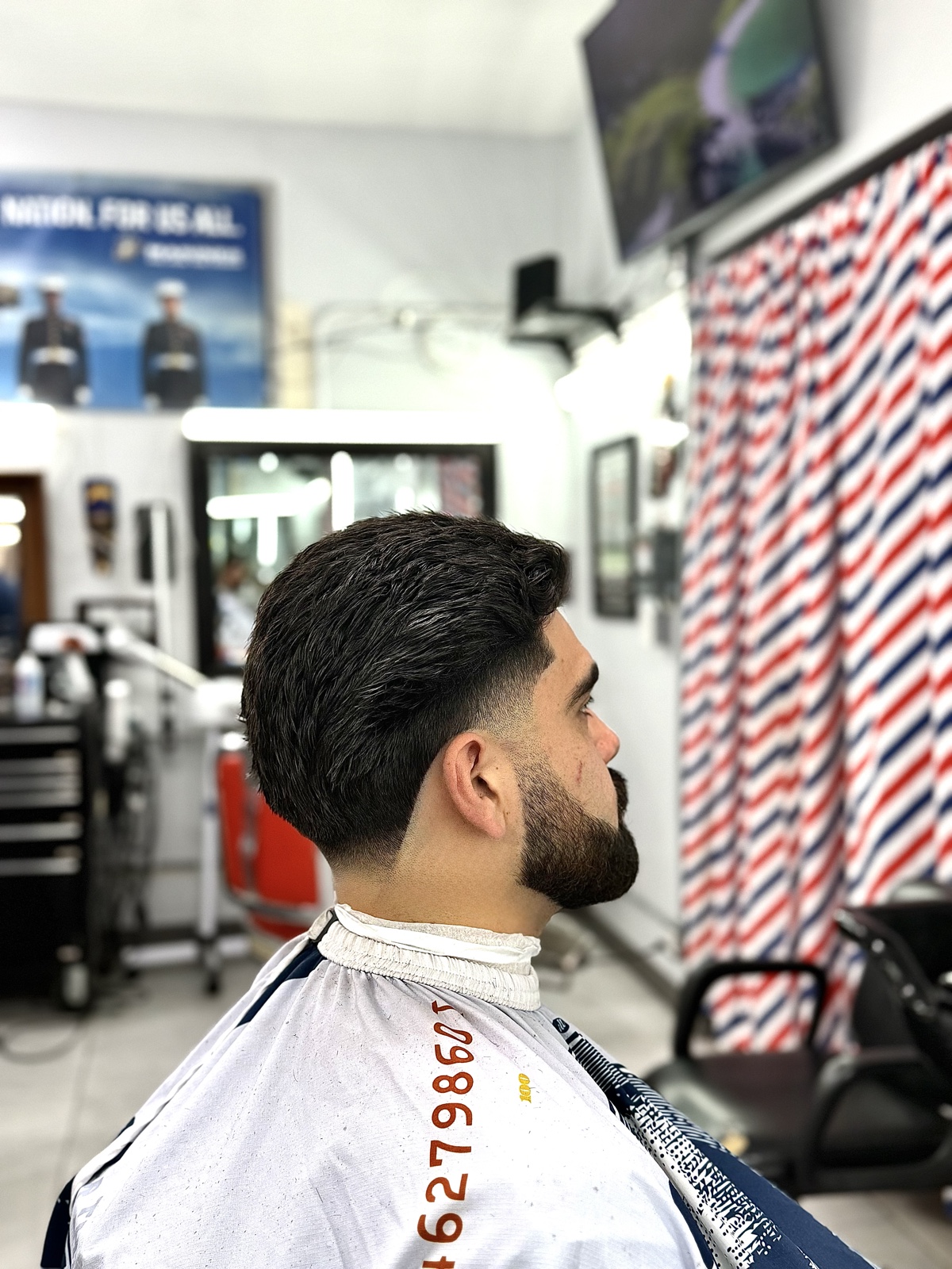 Mid-fade with full beard shape-up